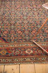 Intricate madder root red border with ivory accents and secured end detail of the Fereghan rug.
