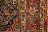 Antique Fereghan rug's intricate Herati motifs, stepped border, and rich, time-softened hues.