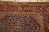 Intricate herati motifs in rich indigo, red, and saffron hues on this Antique Fereghan rug corner.