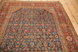 Rich madder red border frames intricate Herati motifs in indigo, saffron, and green.