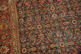 Fine knotting details of this antique Fereghan rug's intricate Herati motif in indigo, madder red, and saffron.