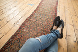 Antique Serab rug runner's paneled design, lattice motifs in camel, madder root, and blue.