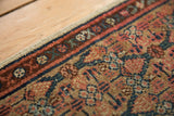 Securely finished side of antique Serab runner with madder red, camel, and blue geometric panels.