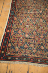 Detailed hand-knotted lattice motif in camel, madder red, and blue on an Antique Serab rug.