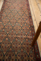 Antique Serab runner's paneled lattice motif in camel, madder red, and sky blue.