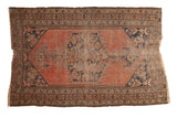 Antique Kurdish Malayer rug, oversized central medallion, Herati-hinting spandrels, faded brick red and navy.