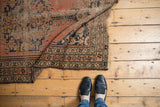Antique Kurdish Malayer rug, its pinwheel floral main border and muted, worn pile.