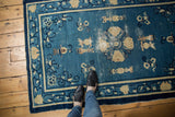 Antique Peking rug: cobalt blue field, ivory Taoist motifs, and concentrated knot head wear.