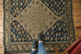 Antique Shirvan square rug, finely woven, with navy, sand, sky blue geometric diamond medallions.