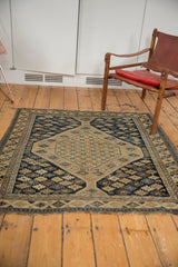 Finely woven antique Caucasian Shirvan rug corner showing geometric starbursts and worn side selvage.