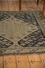 Worn original side selvage of the antique Shirvan rug with sand, navy, sky blue geometric motifs.