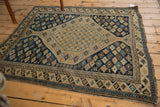 Finely woven antique Shirvan rug corner, worn side selvage, geometric starbursts in navy and beige.
