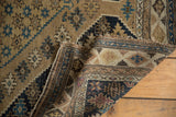 Hand-knotted antique Shirvan rug, showing its worn side selvage and geometric border.