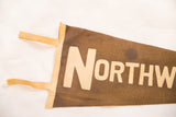 Vintage Northwestern felt pennant: cream 'NORTHW' lettering on faded brown.