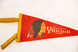 Yellow felt binding and ties detail on a vintage red pennant with chief's profile.