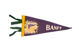 Vintage purple felt Banff pennant, cream beaver, lakeside scene, yellow trim, green ties.