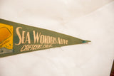 Vintage green felt pennant with 'Sea Wonders Alive Crescent. Calif.' text and frayed tip.