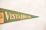 Vintage green felt pennant displaying 'VistaHouse' in cream lettering, with blue discoloration on the tip.