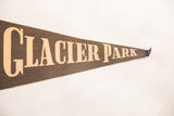 Vintage Glacier Park felt pennant with faded beige lettering on dark felt.