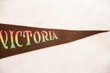 Colorful 'Victoria' lettering on the brown felt pennant tapering to a sharp point.