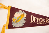 Vintage Depoe Bay Oregon felt pennant graphic of a leaping yellow fish.