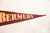 Close-up of vintage Bermuda felt pennant, beige letters on textured dark red.