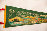 Green felt pennant showcasing 'Seaside, Ore.' text and the colorful lighthouse graphic.
