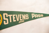 Vintage green felt pennant displaying beige 'Stevens Pass Wash.' lettering.