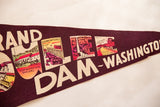 Vibrant landmark illustrations within the text of the Grand Coulee Dam felt pennant.