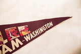 The pointed tip of the vintage Washington pennant with cream lettering on maroon felt.