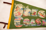 Vintage Oregon Coast felt pennant, yellow binding, brown ties, pin-up girl imagery.