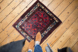 A vintage Persian Engelas rug with a classic red and blue Herati design, shown in-situ for scale.