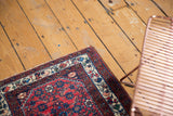 Vintage Engelas rug corner highlighting the detailed floral border and rich, cherry red field.