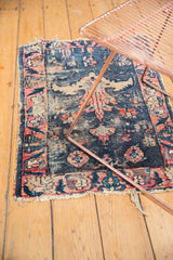 Antique Lilihan rug corner: denim blue, raspberry rose floral motifs, moderate tatter, worn fringe.