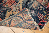 Antique Lilihan rug corner showing worn denim blue pile, woven foundation, and tattered fringe.