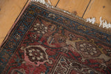 Antique Kurdish Bijar rug edge, revealing storied wear, exposed foundation, and geometric floral patterns.