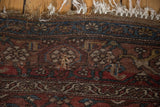 Antique Kurdish Bijar rug: tattered fringe, geometric motifs, and visible foundation wear.