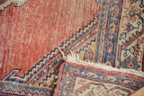 Antique Malayer runner, folded back, revealing blush cinnabar red abrash and tattered foundation with blue border.