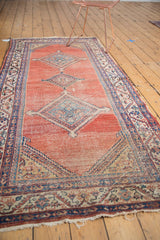 Antique Malayer runner, triple diamond medallions on a blush abrash field, tattered ends.