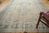 Distressed vintage Oushak rug with faded charcoal patterns and visible foundation.