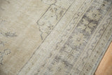 Vintage distressed Oushak rug detail showing worn pile and visible foundation.