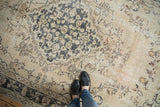 Distressed Sivas carpet, beige, charcoal blue, blush vinery, showing mostly even wear.
