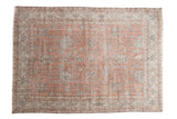 Distressed vintage Sparta rug featuring faded dusty rose and ivory allover floral motifs.