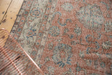 Dusty rose, ivory, and blue scrolling palmette pattern on distressed vintage Sparta rug.