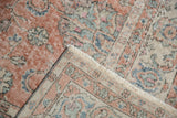 Distressed vintage Sparta rug showing even wear, faint foundation, and dusty rose vinery.