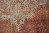 Distressed texture of hand knotted Oushak rug with rust, ivory, and sky blue colors.