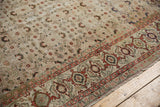 Distressed Kaisary carpet displays faded cherry red samovar border with pale apricot herati field.