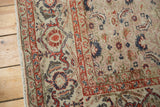 Detail of distressed vintage Kaisary carpet, herati motif, cherry red border, exposed knots.