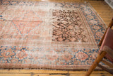 Distressed Hamadan runner with low pile, chocolate brown, blush, and sky blue herati patterns.