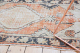 Distressed Oushak rug runner border detail in charcoal, dusty brick red, and antique ivory.